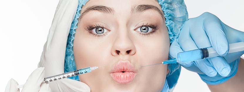 Attractive woman at plastic surgery with syringe in her face
